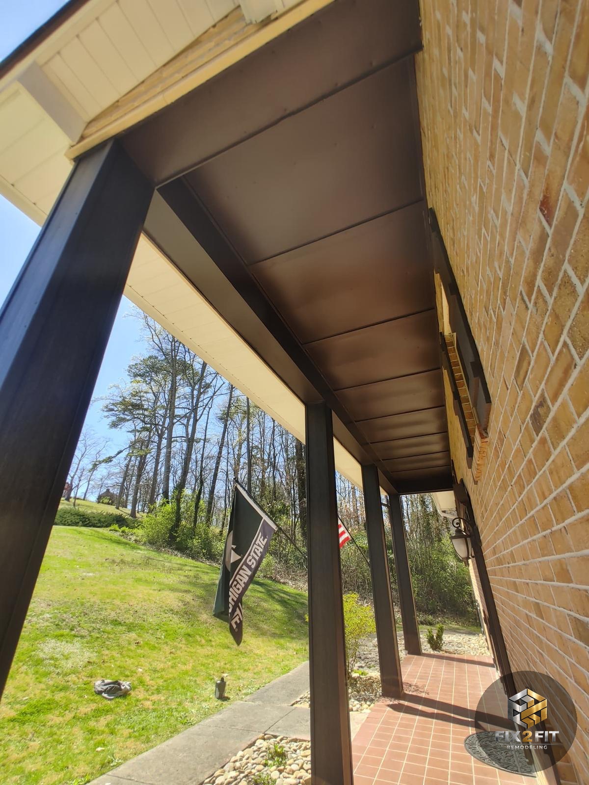 Covered porch with freshly painted ceiling, posts and trim